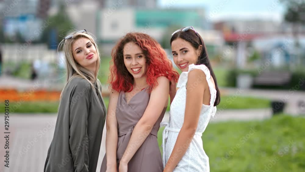 Three diverse young girl friend having fun posing together outdoor looking at camera Three diverse young girl friend having fun posing together outdoor looking at camera