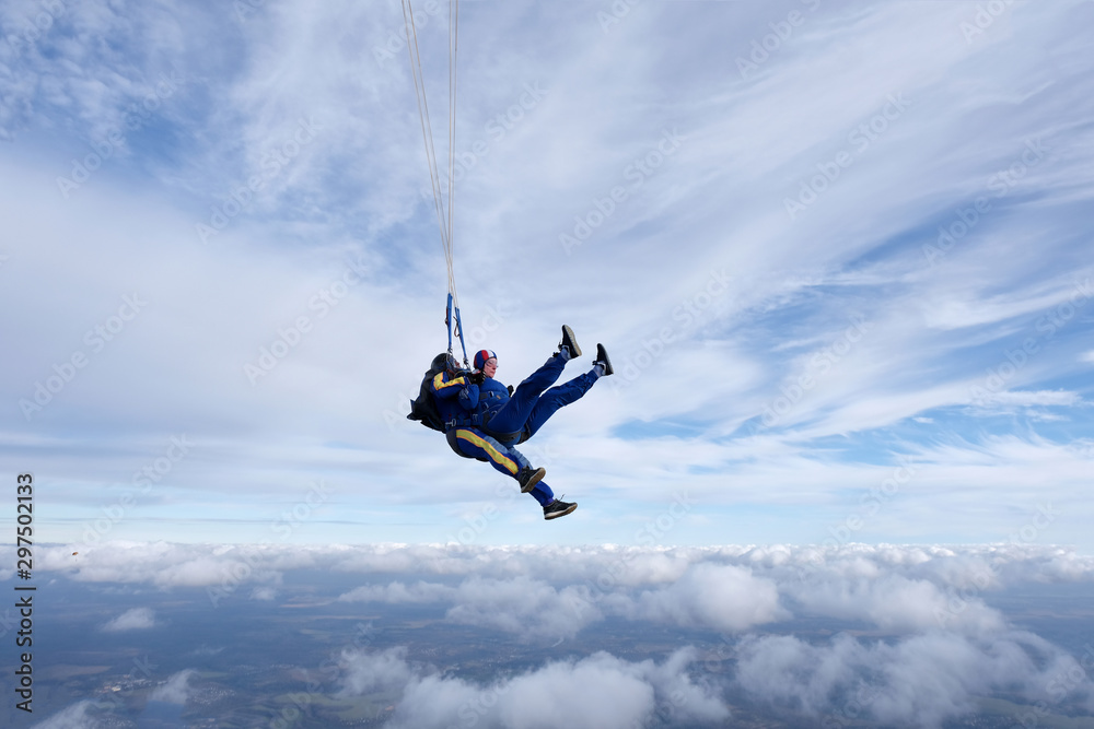Skydiving. Tandem jump. Two skydivers are in the sky. Skydiving. Tandem jump. Two skydivers are in the sky.
