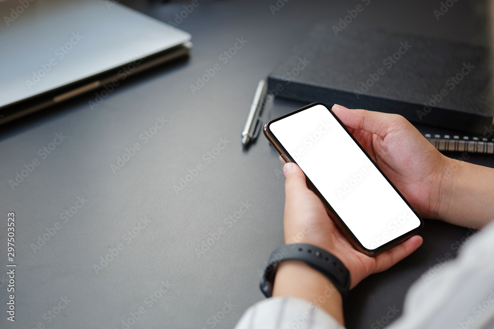 Cropped shot view Mock up smartphone of hand holding black mobile phone with blank white screen. Cropped shot view Mock up smartphone of hand holding black mobile phone with blank white screen.