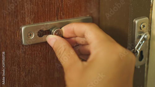 wooden door locked by door latch and chain in vintage style.for security