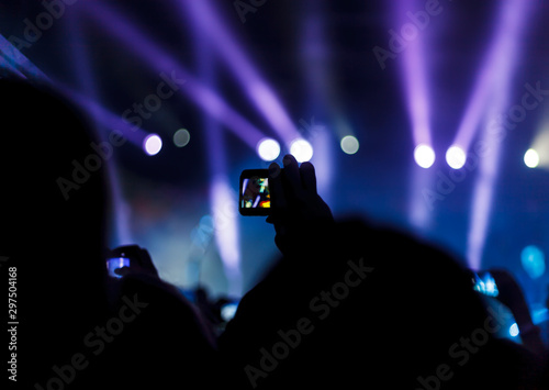 Silhouettes of people and musicians in big concert stage