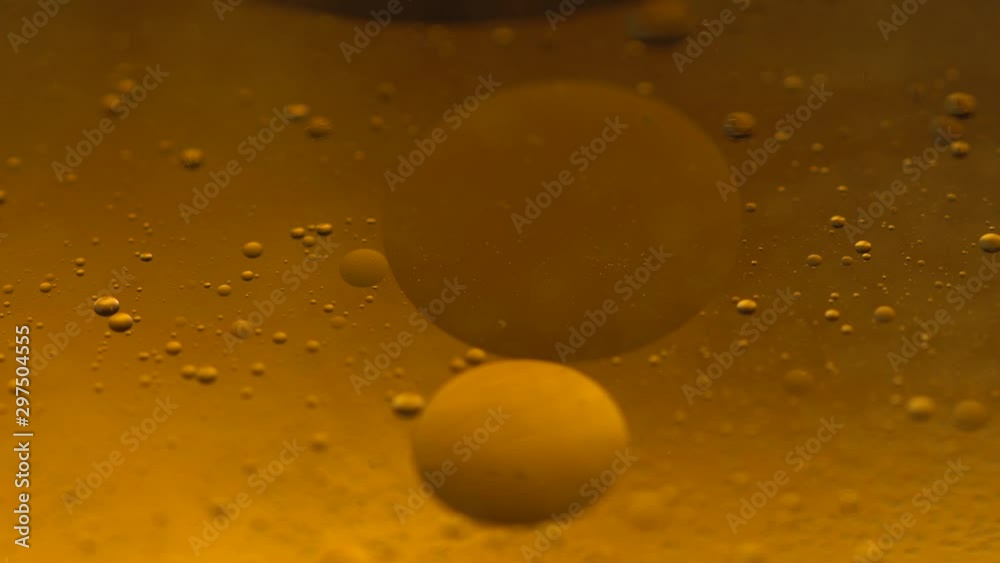 Abstract colorful background. Foam of Soap with Bubbles macro shot. Closeup bubbles in water. Oil drops on a water surface abstract background. Golden yellow bubble.Yellow water bubbles wallpaper. 4k Abstract colorful background. Foam of Soap with Bubbles macro shot. Closeup bubbles in water. Oil drops on a water surface abstract background. Golden yellow bubble.Yellow water bubbles wallpaper. 4k