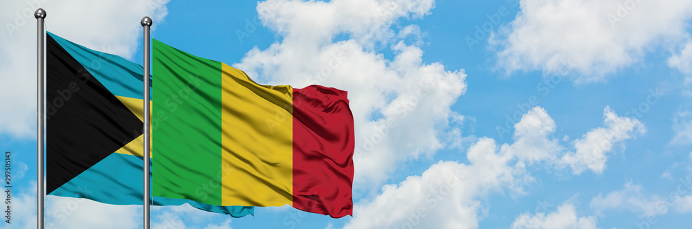 Obraz premium Bahamas and Mali flag waving in the wind against white cloudy blue sky together. Diplomacy concept, international relations.