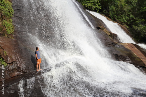 Man and Chet Si waterfall at Bueng Kan Province,Thailand