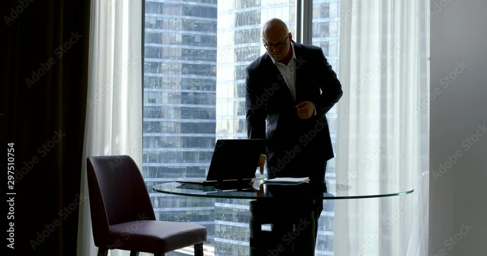 male top manager is working in office alone, reading papers and typing on smartphone male top manager is working in office alone, reading papers and typing on smartphone