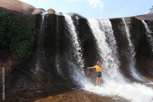 Women playing in the water at Tham Phra Waterfall  in Bueng Kan, Thailand.