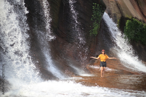 Women playing in the water at Tham Phra Waterfall  in Bueng Kan, Thailand.