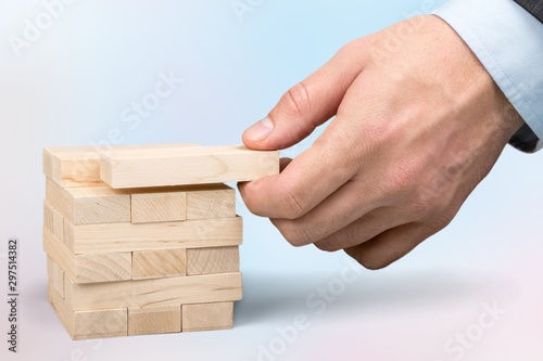 Male hand ready to push domino