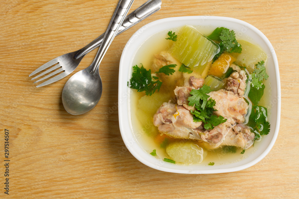 Chicken Clear soup in White Bowl on Wooden Table