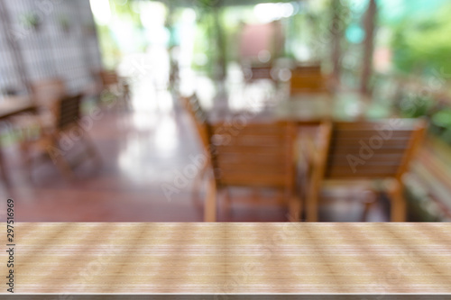 Top desk with blur restaurant background wooden table