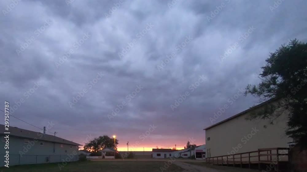 TIME LAPSE - Clouds over a small town at dusk. TIME LAPSE - Clouds over a small town at dusk.
