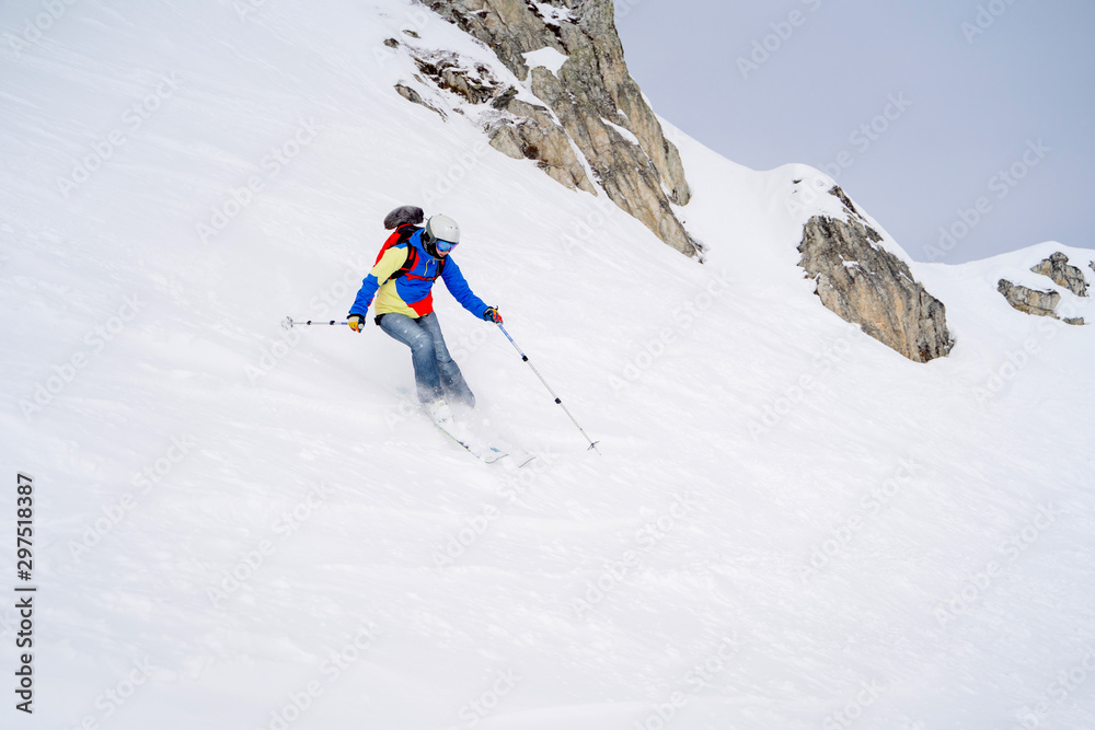 Sports girl skiing on snowy slope.