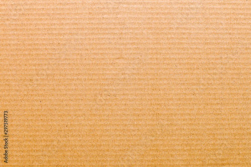 Top view closeup sheet of striped whole brown cardboard. Modern trendy abstract texture background