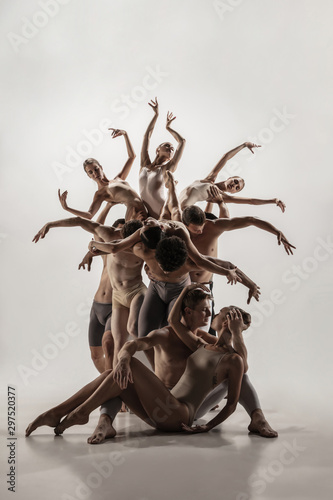 The group of modern ballet dancers. Contemporary art ballet. Young flexible athletic men and women in ballet tights. Studio shot isolated on white background. Negative space. © master1305