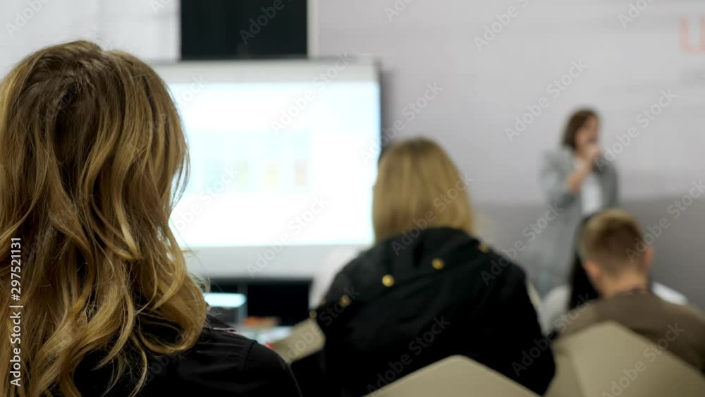 Female speaker or coach on the training business seminar. Female speaker or coach on the training business seminar.