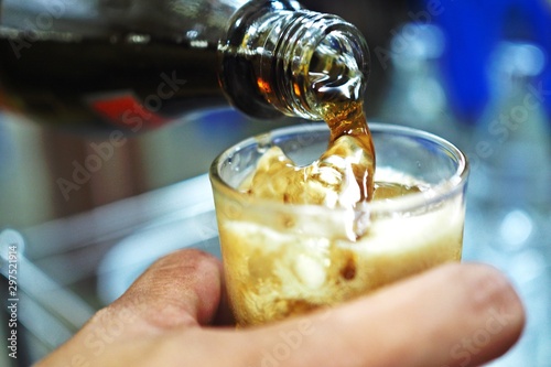glass of cola with ice cubes
