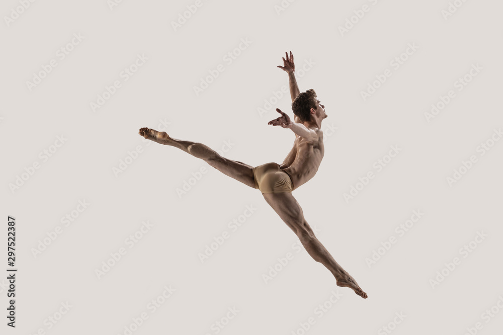 Fototapeta Modern ballet dancer. Contemporary art ballet. Young flexible athletic man.. Studio shot isolated on white background. Negative space.