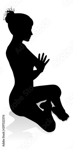 A silhouette of a woman in a yoga or pilates pose