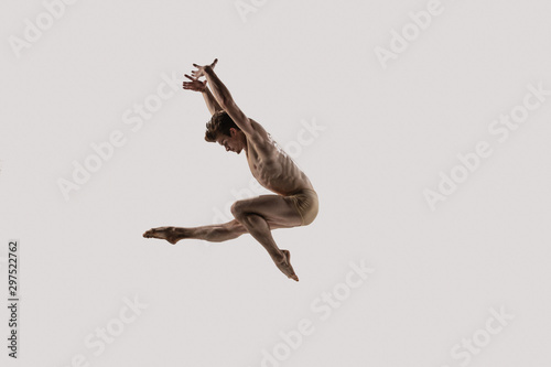 Modern ballet dancer. Contemporary art ballet. Young flexible athletic man.. Studio shot isolated on white background. Negative space.