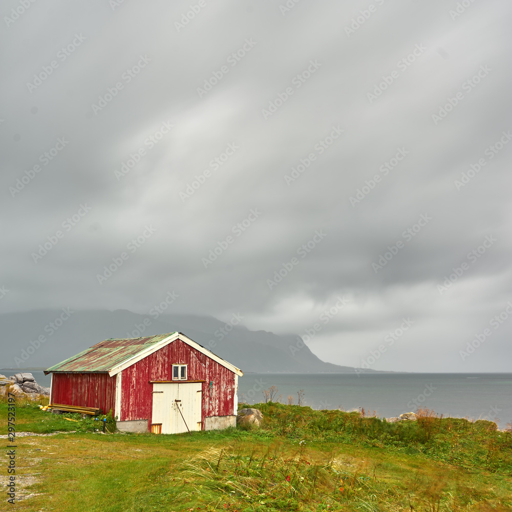 Red house with dark clouds Red house with dark clouds