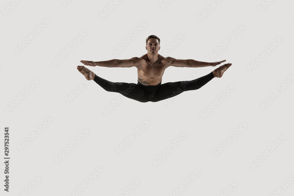 Modern ballet dancer. Contemporary art ballet. Young flexible athletic man.. Studio shot isolated on white background. Negative space. Modern ballet dancer. Contemporary art ballet. Young flexible athletic man.. Studio shot isolated on white background. Negative space.
