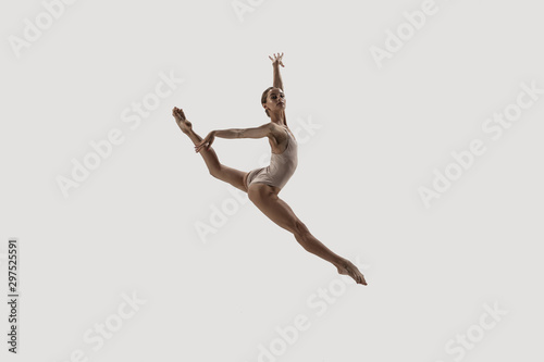 Modern ballet dancer. Contemporary art ballet. Young flexible athletic woman.. Studio shot isolated on white background. Negative space. © master1305