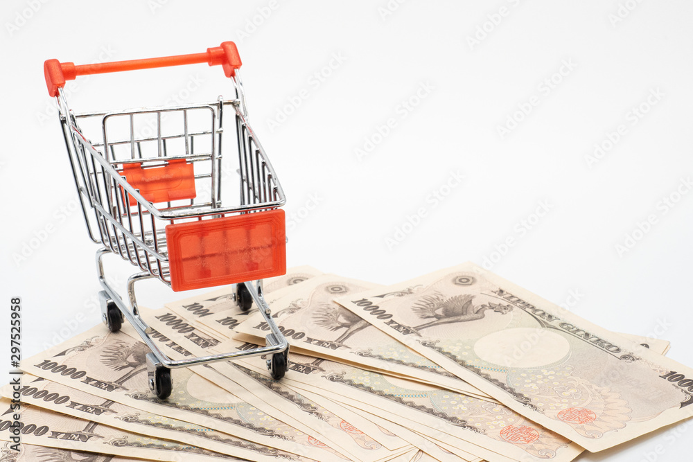 Close up japanese currency yen money banknote in small shopping trolley . Background concept for japan  economy and online market.