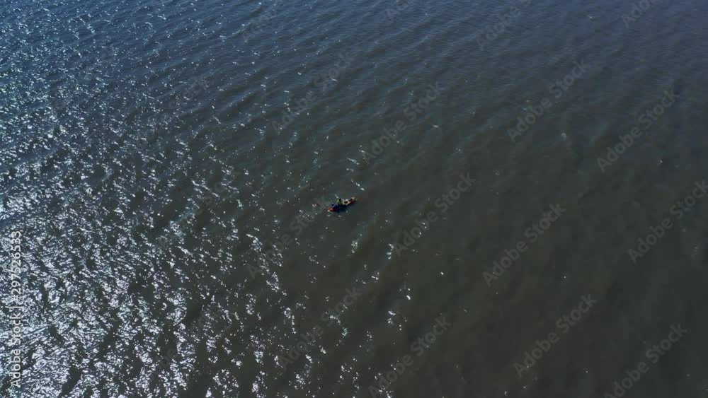 A man in a canoe fishing for food. Calm waters, Aerial, slow movement, top view. River over capital city, Vicente Lopez, Buenos Aires, Argentina, Río de la Plata. Spring 2019. A man in a canoe fishing for food. Calm waters, Aerial, slow movement, top view. River over capital city, Vicente Lopez, Buenos Aires, Argentina, Río de la Plata. Spring 2019.