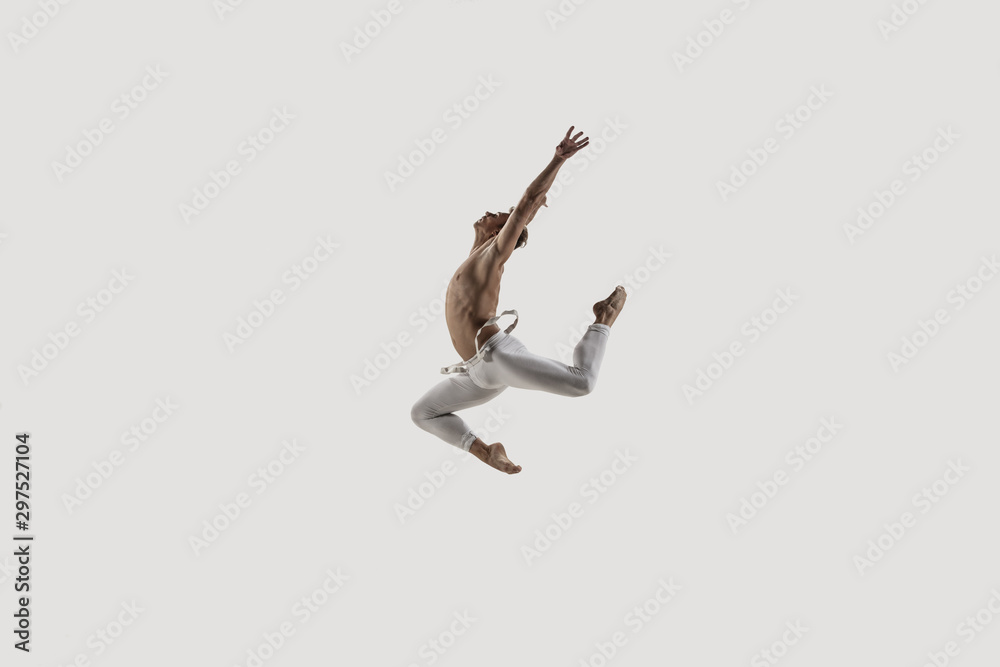 Modern ballet dancer. Contemporary art ballet. Young flexible athletic man.. Studio shot isolated on white background. Negative space.