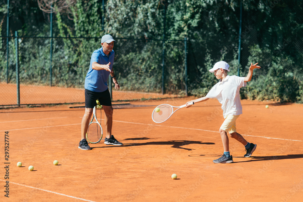 Tennis Instructor with Boy in Tennis Lesson. Tennis Instructor with Boy in Tennis Lesson.