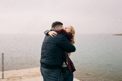 couple hugging on a pier