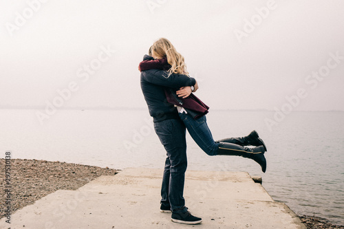 couple hugging on a pier