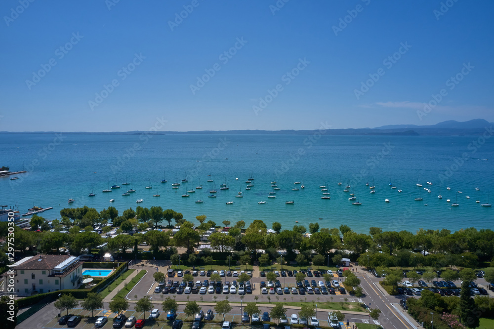 Aerial photography. Beautiful coastline. In the city of Bardolino, Lake Garda is the north of Italy. View by Drone. Car parking.
