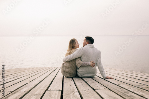 couple hugging on a pier