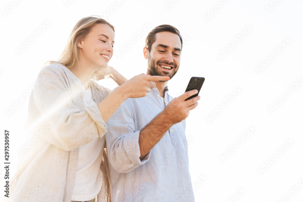 Beautiful happy young couple spending time at the beach Beautiful happy young couple spending time at the beach