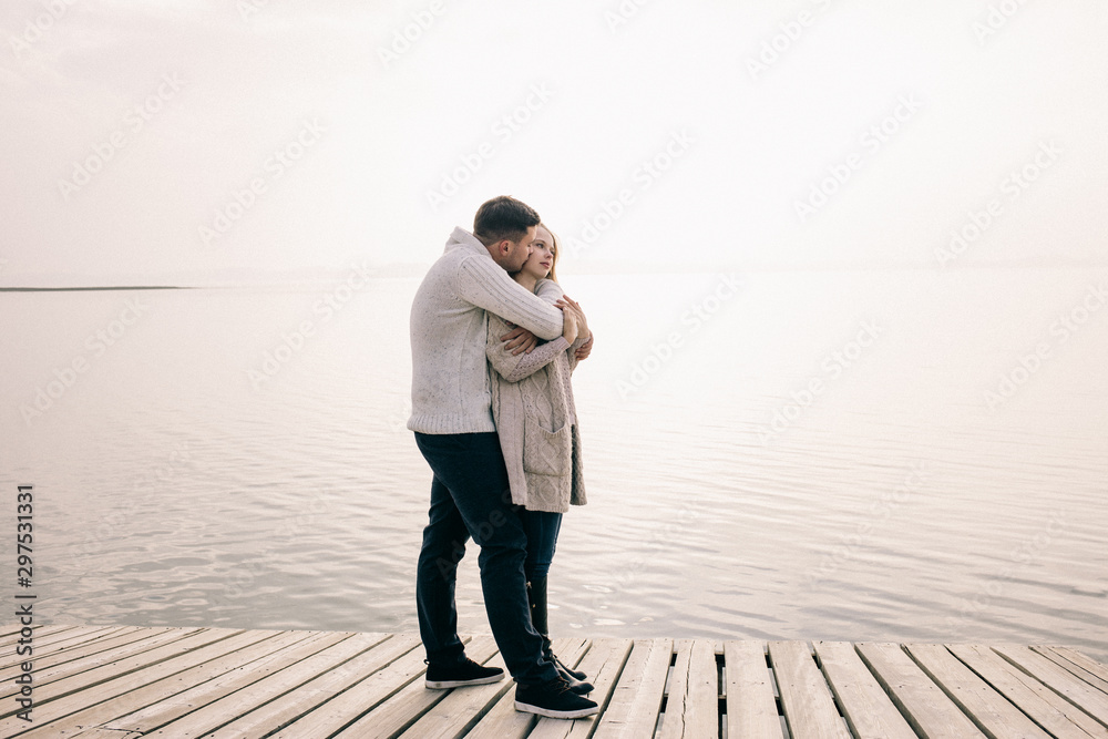 couple hugging on a pier