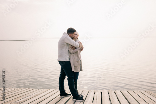 couple hugging on a pier