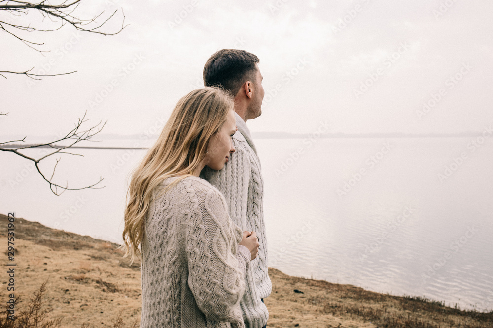 couple hugging on a pier