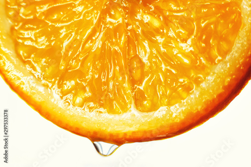 orange slice with a drop of water close up on a white background