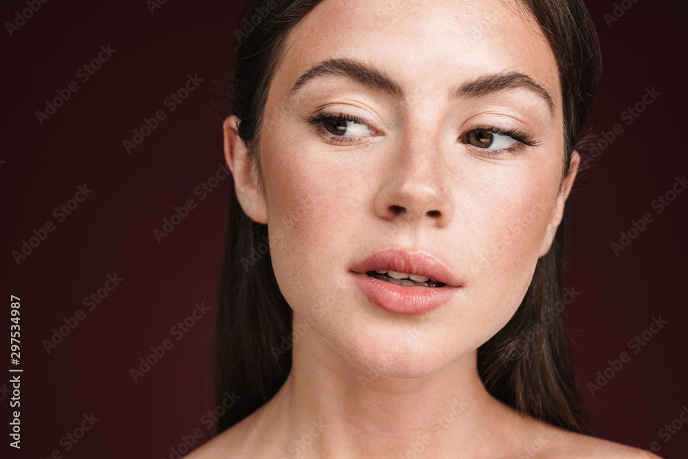 Fototapeta premium Image of seductive half-naked woman posing and looking aside