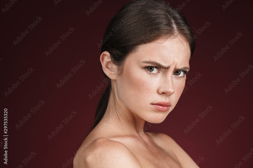 Image of displeased half-naked woman posing and looking at camera Image of displeased half-naked woman posing and looking at camera