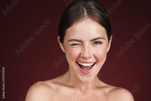 Image of smiling half-naked woman winking and looking at camera