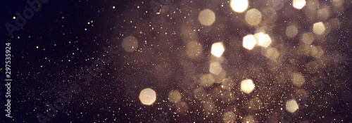 background of abstract glitter lights. gold and black. de focused. banner © tomertu