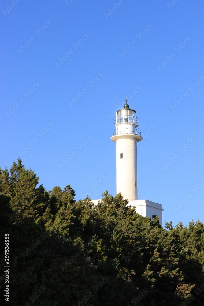 Beacon of Lefkada island south cape lighthouse tower shine at sunlight in summer, clear blue sky at background