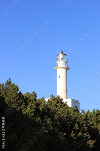 Beacon of Lefkada island south cape lighthouse tower shine at sunlight in summer  clear blue sky at background