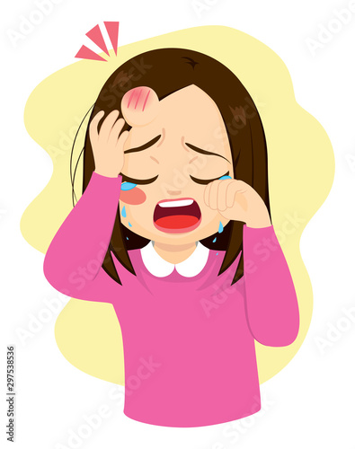 Young little girl crying in pain with bump bruise on forehead