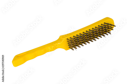 Wire brush on a white background. Metal brush with a yellow handle.
