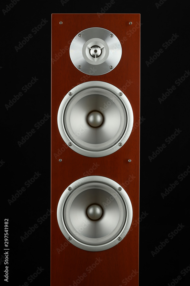 Red wooden high gloss music speakers tower isolated on black background Red wooden high gloss music speakers tower isolated on black background