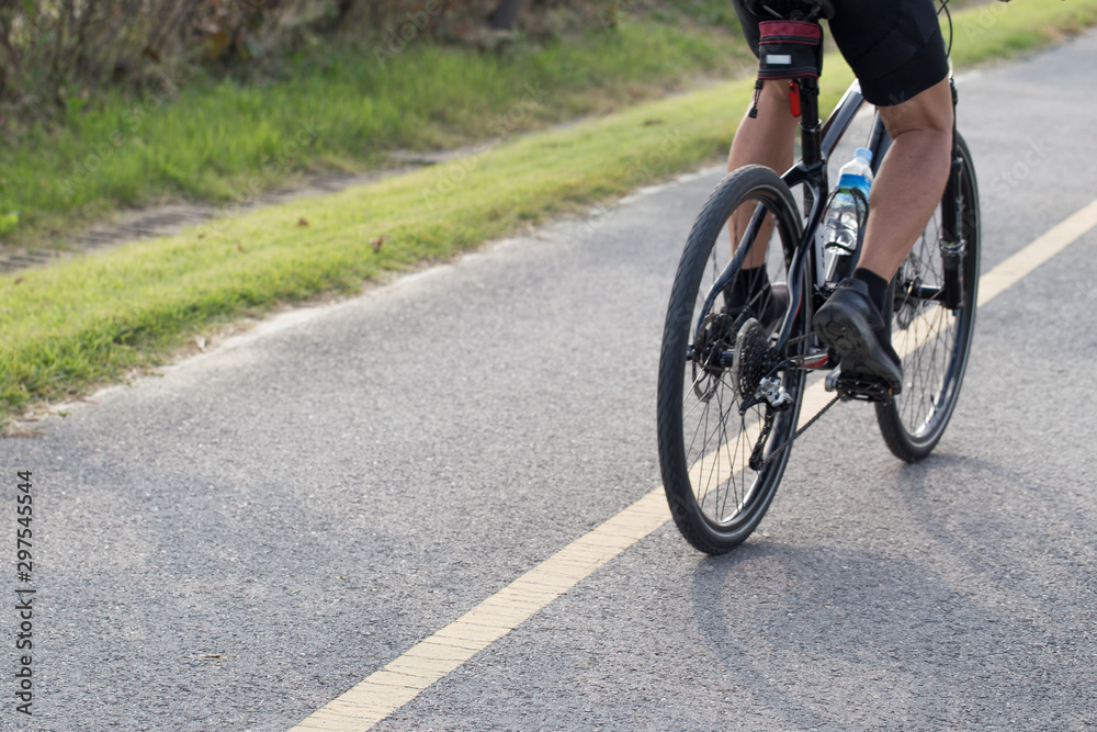Men are cycling road bike. view from behind Men are cycling road bike. view from behind