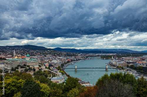 Autumn panoramic view from Gellert Hill to Buda Castle and King Palace Budavári Palota of the Hungarian kings and river Danube with Széchenyi Chain Bridge on stormy weather